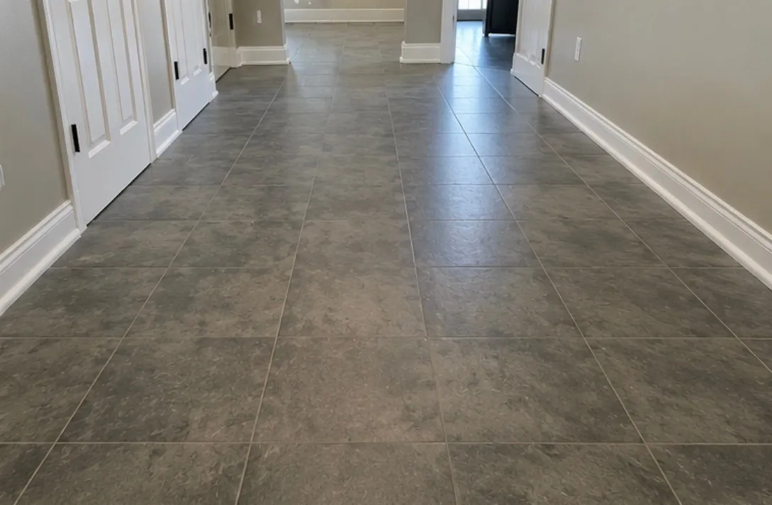 Large-format porcelain tile down a long hallway