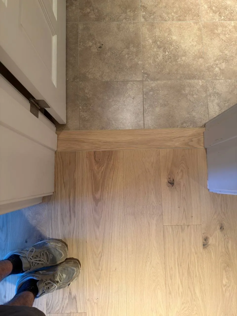 Flush transition between stone-look tile and wood-look plank flooring